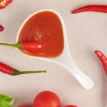 Spicy sauce in a ladle